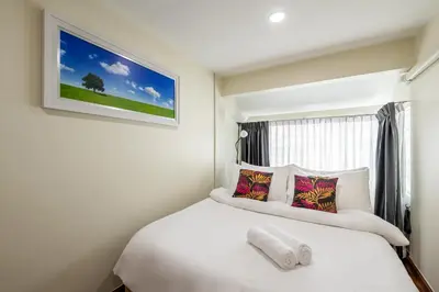 a bedroom with a white bed and a window at At FOUR-6 Bed, CITY CENTER, Nana BTS, MBK, Central World, Siam in Bangkok