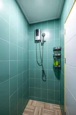 a bathroom with a shower with blue tiles at At FOUR-6 Bed, CITY CENTER, Nana BTS, MBK, Central World, Siam in Bangkok
