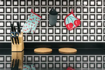 a shelf with scissors and utensils on a wall at At FOUR-6 Bed, CITY CENTER, Nana BTS, MBK, Central World, Siam in Bangkok