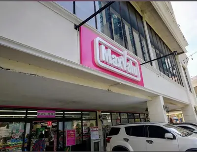 a walmart store with a car parked in front of it at Nato house Ekkamai in Bangkok