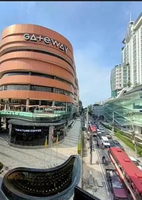 a large building with a sign on the side of it at Nato house Ekkamai in Bangkok