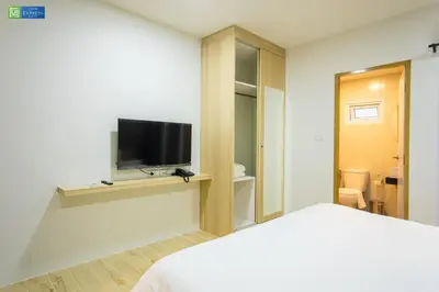 a bedroom with a bed and a flat screen tv at Zayn Express & Suites in Bangkok