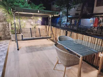 a patio with a table and chairs and a fence at Canal View Lo-ha guest house, Contactless Check-in in Bangkok