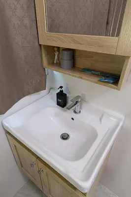 a white sink in a bathroom with a mirror at Canal View Lo-ha guest house, Contactless Check-in in Bangkok