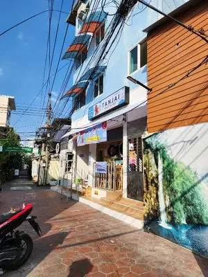 a building on a street with a motorcycle parked in front at Canal View Lo-ha guest house, Contactless Check-in in Bangkok