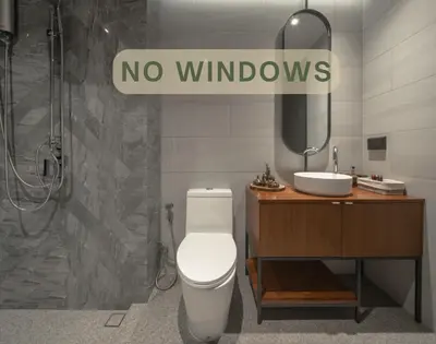 a bathroom with a toilet and a sink and a no windows sign at Goose Living in Bangkok