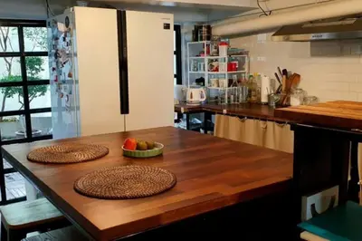 a kitchen with a table with two plates of fruit on it at Beautiful 5 Story Family House in Bangkok