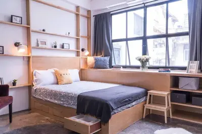 a bedroom with a bed and a desk and windows at Beautiful Super Modern Gigantic Designer Home in Bangkok