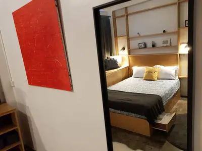 a mirror reflection of a bed in a room at Beautiful Super Modern Gigantic Designer Home in Bangkok