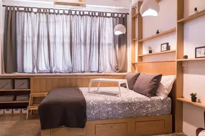 a small bedroom with a bed and a window at Beautiful Super Modern Gigantic Designer Home in Bangkok