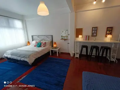 a bedroom with a bed and a table and chairs at Big Groups Heaven in Central Location in Bangkok
