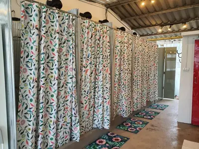 a wall of curtains in a room with mats at Great House for Families and Big Groups in Bangkok