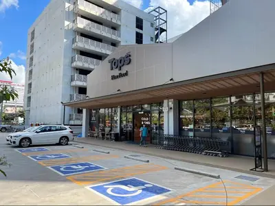 a car parked in a parking lot in front of a building at Nato House Ekkamai -BTS Ekkamai with balcony in Bangkok