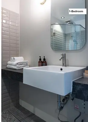 a bathroom with a white sink and a mirror at karaarom hotel in Bangkok