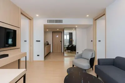 a living room with a couch and a tv at Best Western Nada Don Mueang Airport hotel in Bangkok