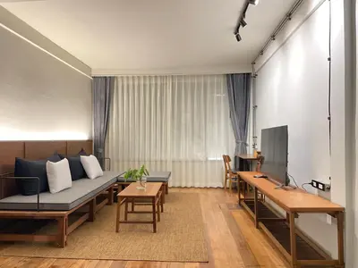 a living room with a couch and a table at GalileOasis Boutique Hotel in Bangkok