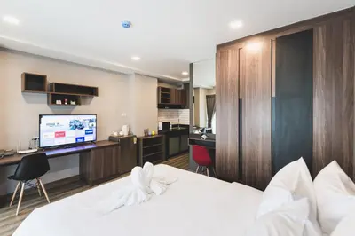 a hotel room with a bed and a tv at W2 RESIDENCE in Ban Zong Katiam