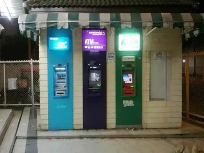two atm machines on the side of a building at T8 Guest House Don Mueang Challenger in Ban Song Hong