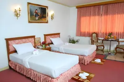 a hotel room with two beds and a table at OYO 75466 -13 Coins Bang Yai Hotel in Ban Sai Ma