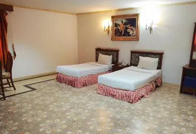 a hotel room with two beds and a picture on the wall at OYO 75466 -13 Coins Bang Yai Hotel in Ban Sai Ma