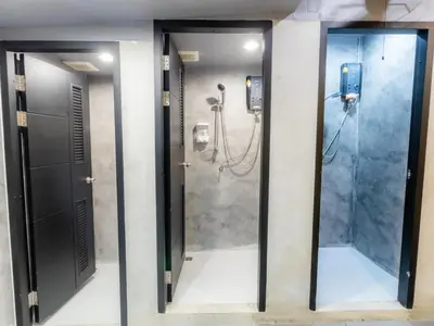 a bathroom with a shower and a walk in shower at Khao San Social Capsule Hostel in Bangkok