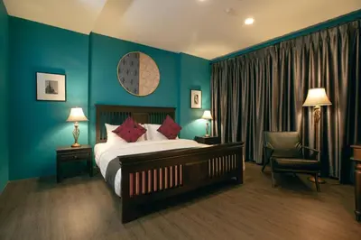 a hotel room with a bed and a chair at Caiyong Hometel & Cafe's Studio in Khlong San