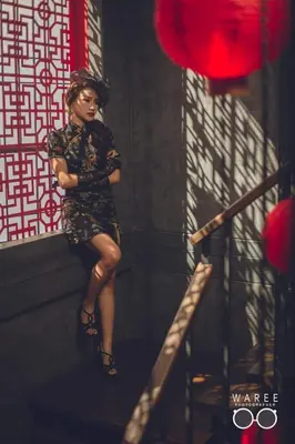 a woman sitting on a step in a room at Caiyong Hometel & Cafe's Studio in Khlong San