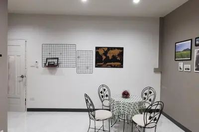 a dining room with a table and chairs at 8FINITE House in Bang Su