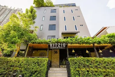 a building with a staircase in front of it at Kitzio House Hotel Huai Kwang in Bangkok
