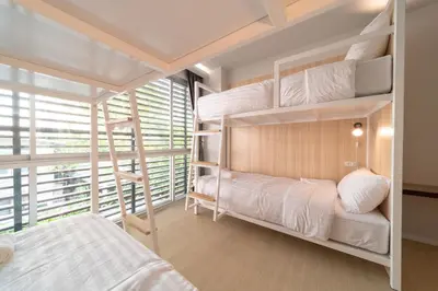 a bedroom with two bunk beds and a window at Kitzio House Hotel Huai Kwang in Bangkok