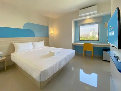 a bedroom with a bed and a desk and a television at HOP INN Bangkok Bangna in Bangkok