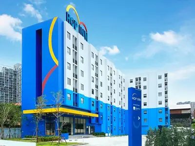 a hotel with a blue and white building at HOP INN Bangkok Onnut Station in Bangkok