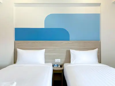 two beds sitting next to each other in a room at HOP INN Bangkok Onnut Station in Bangkok