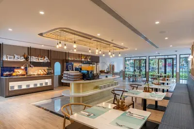 a restaurant with tables and chairs in a building at Centara Life Hotel Bangkok Phra Nakhon in Bangkok