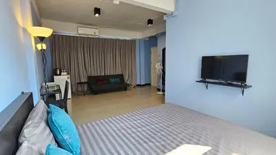 a bedroom with a bed and a flat screen tv at HOUSEMODE - BAANYAI @ Wongwian Yai in Bangkok