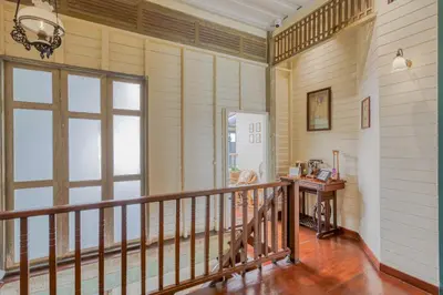 a room with a balcony with a large window at Priya Boutique House in Bangkok