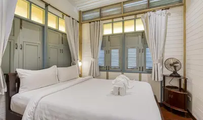 a bedroom with a bed with a stuffed animal on it at Priya Boutique House in Bangkok