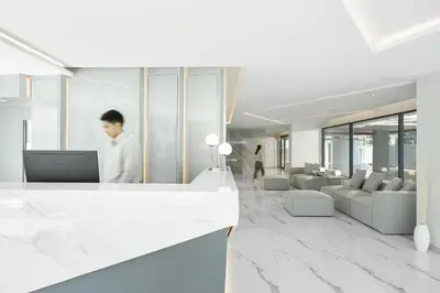 a man standing at a counter in a lobby at Livable Hotel Bangkok in Bangkok