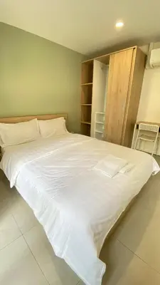 a large white bed in a room at POP Heritage Residence in Bangkok
