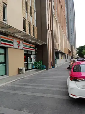 a street with cars parked in front of buildings at Plum central westgate@Bangyai in Ban Bang Krabu