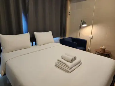 a bedroom with a white bed with towels on it at Lo-Ha Guest house, Contactless Check-in in Bangkok