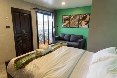 a bedroom with a large bed and a couch at Lo-Ha Guest house, Contactless Check-in in Bangkok
