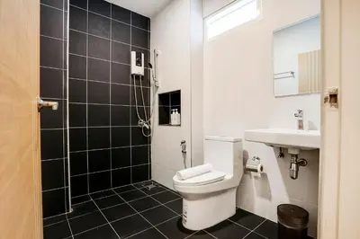 a bathroom with a toilet and a sink at TAKKA Hotel - Bangna in Bangna