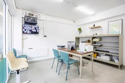 an office with a desk with chairs and a computer at TAKKA Hotel - Bangna in Bangna
