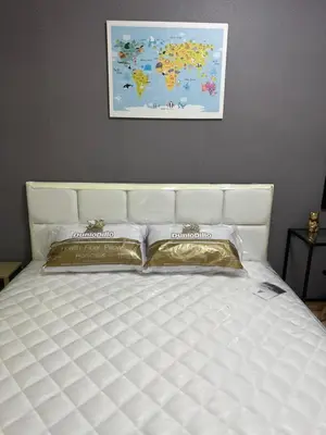 a white bed with two pillows on top of it at S Villa @Impact Muangthongthani in Pak Kret