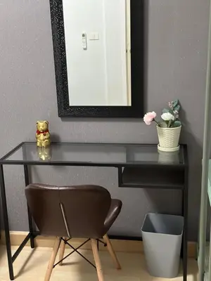 a black desk with a mirror and a chair at S Villa @Impact Muangthongthani in Pak Kret