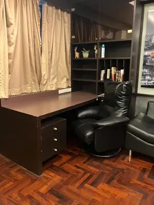 a office with a desk and a chair at Flourish Apartments in Bangkok