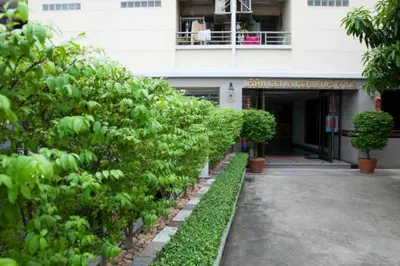 a building with a row of bushes in front of it at S.K. Residence in Bangkok