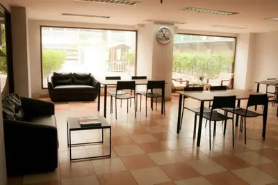 a living room with a table and chairs at S.K. Residence in Bangkok
