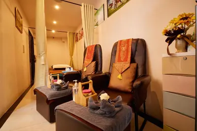 a living room with two chairs and stuffed animals at Rose Apple Hotel in Bangkok